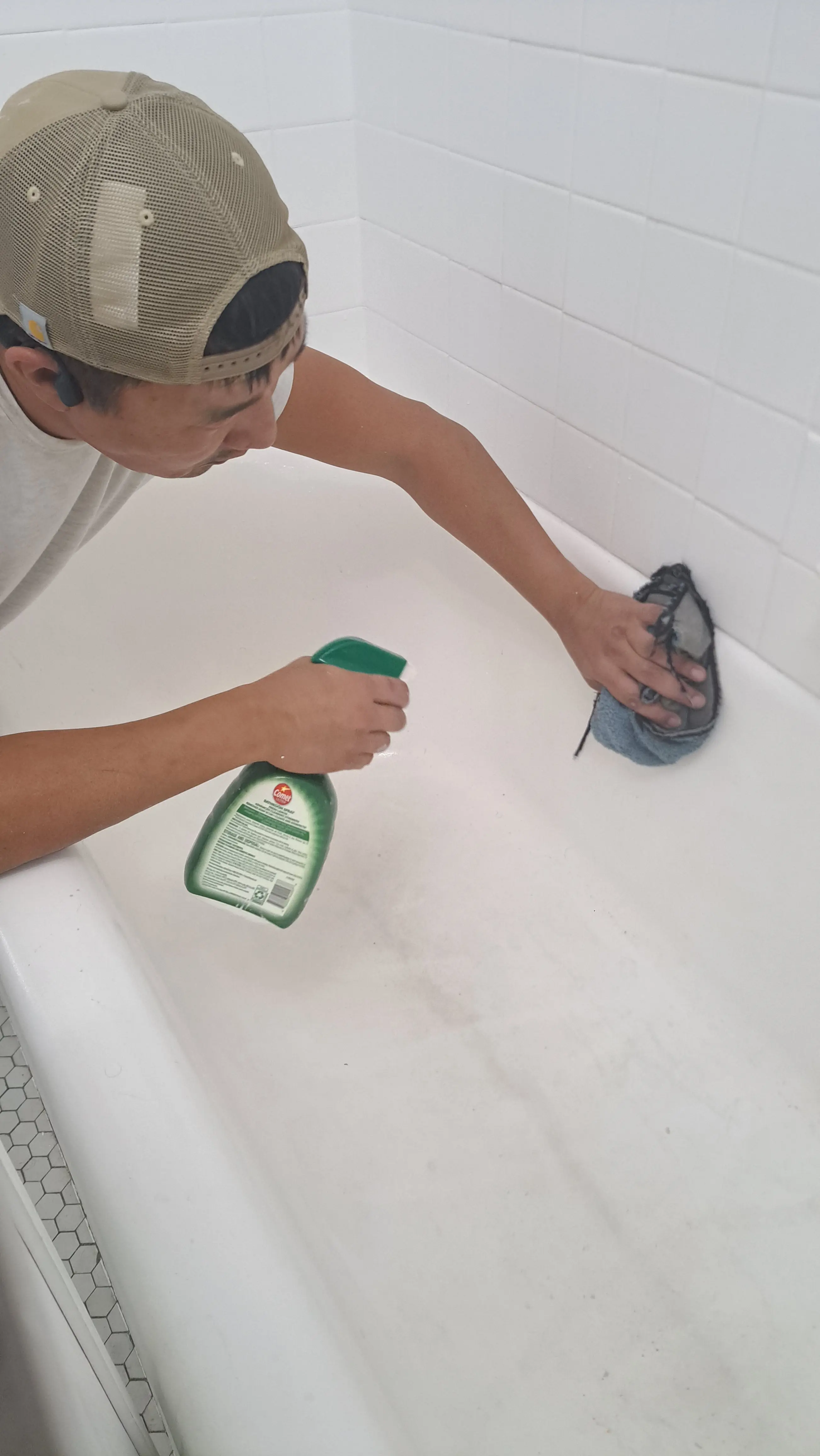 Masking tile and walls to protect the Park Ridge bathroom during refinishing